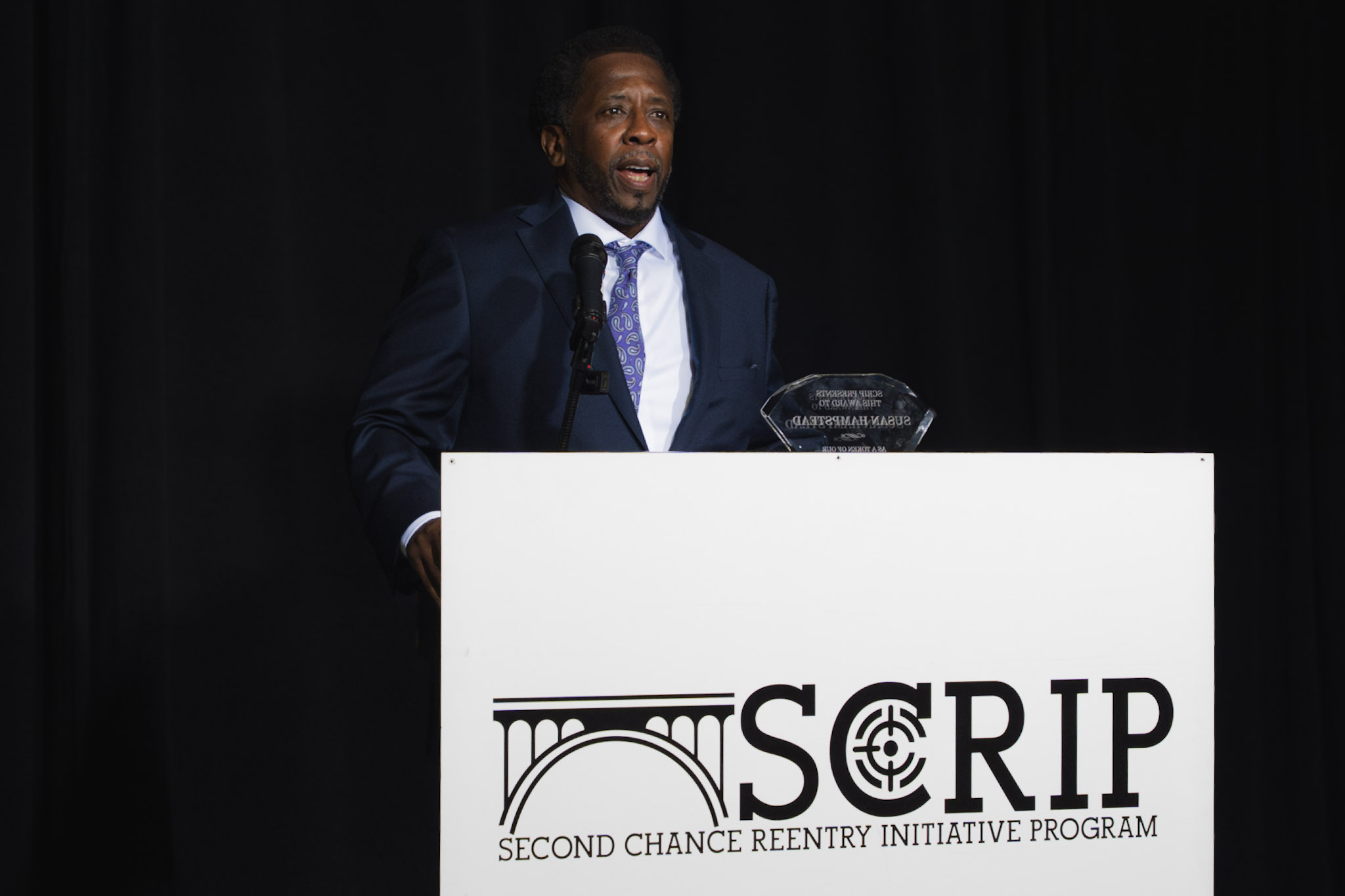 Edward L. Andrews speaking at a SCRIP event